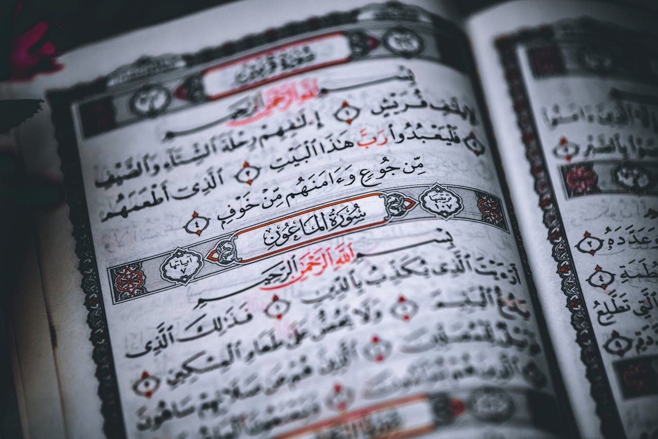 gallery-6 Detailed close-up of Quran pages with Arabic calligraphy in a traditional script.