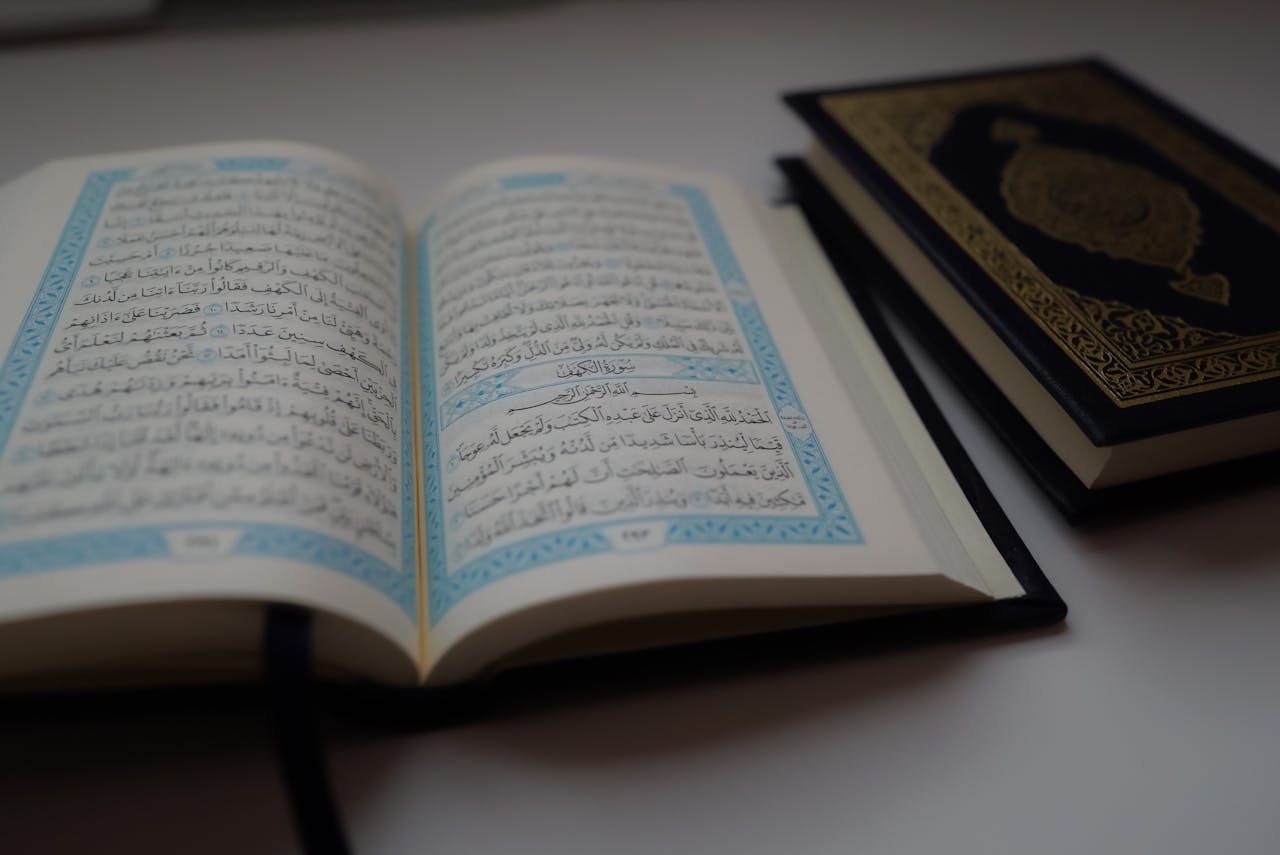 Close-up of an open Quran with Arabic text, focusing on religious and cultural elements.